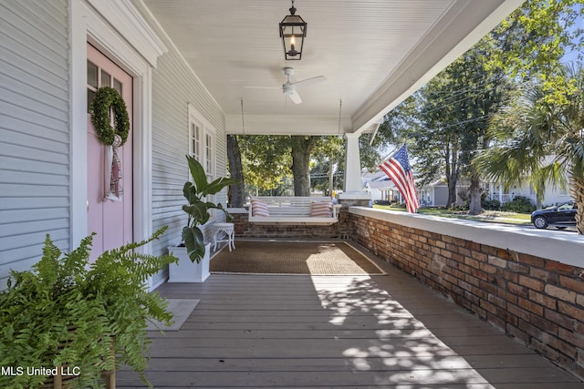 wooden terrace with covered porch and ceiling fan
