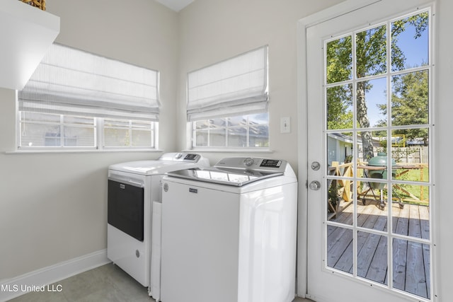 laundry area with washer and dryer, laundry area, plenty of natural light, and baseboards