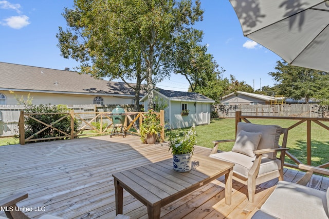 deck with a storage shed and a lawn