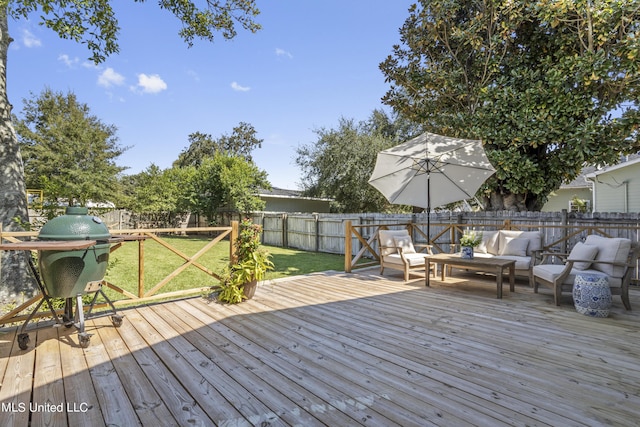 wooden deck with a fenced backyard, outdoor lounge area, and a yard