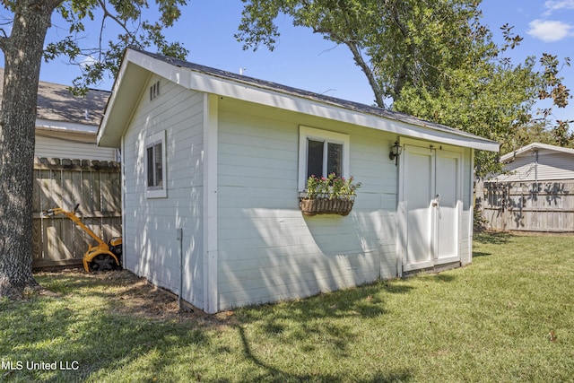 view of outbuilding with fence and an outdoor structure