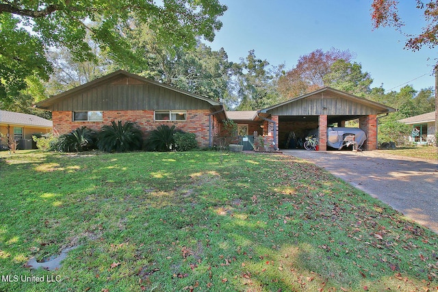719 Holly Hills Dr, Biloxi, MS 39532 - view of front of home with asphalt driveway, a front lawn, brick siding, and a carport
