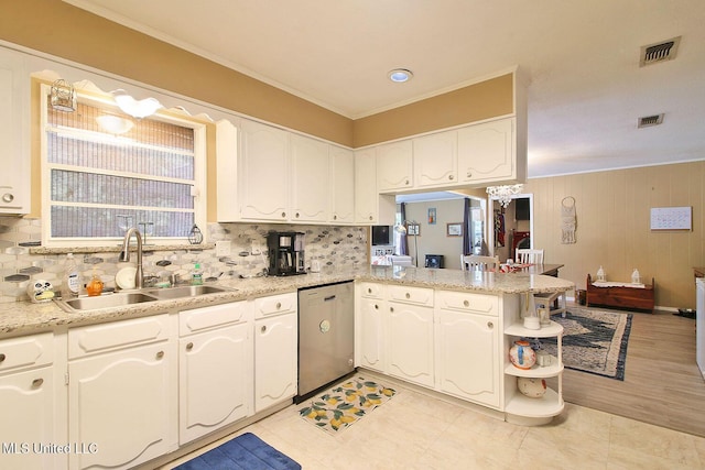 719 Holly Hills Dr, Biloxi, MS 39532 - kitchen featuring dishwasher, backsplash, white cabinets, crown molding, and wood walls