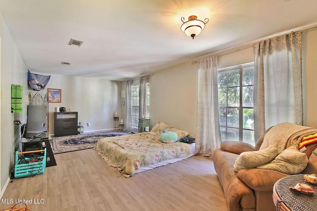719 Holly Hills Dr, Biloxi, MS 39532 - bedroom with multiple windows and wood finished floors