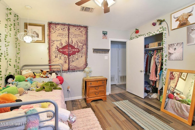 719 Holly Hills Dr, Biloxi, MS 39532 - bedroom with a closet, wood finished floors, and a ceiling fan