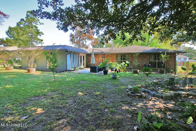 719 Holly Hills Dr, Biloxi, MS 39532 - rear view of house featuring a lawn