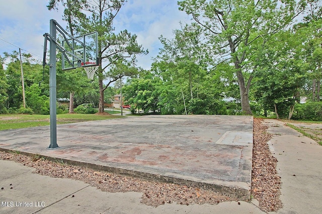 719 Holly Hills Dr, Biloxi, MS 39532 - view of basketball court featuring basketball hoop and view of scattered trees