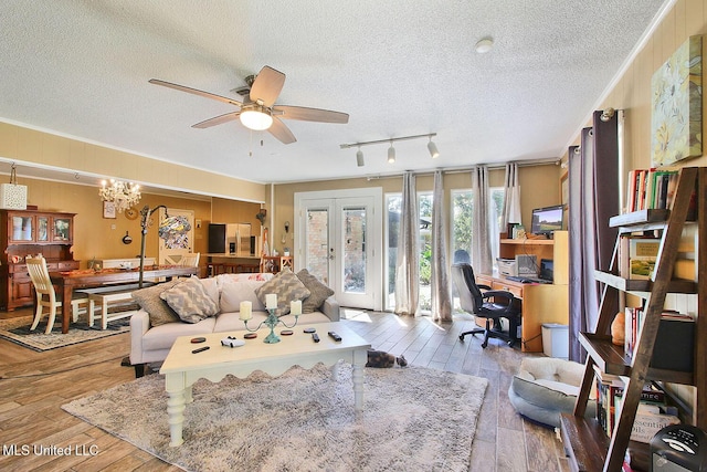 719 Holly Hills Dr, Biloxi, MS 39532 - living area with a textured ceiling, wood-type flooring, french doors, ceiling fan, and an office area