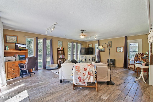 719 Holly Hills Dr, Biloxi, MS 39532 - living room featuring rail lighting, a textured ceiling, an office area, wood finished floors, and crown molding