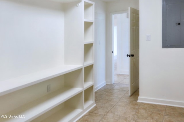 hall featuring electric panel and light tile patterned floors