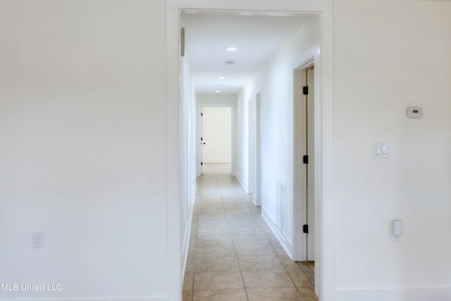 hall with light tile patterned floors