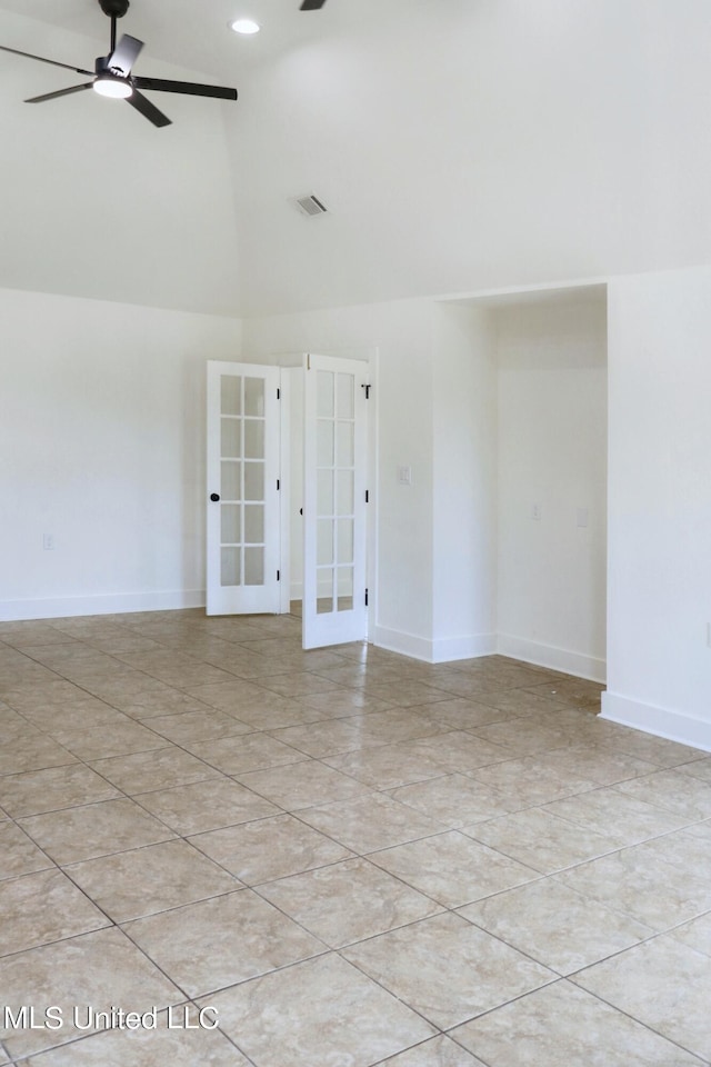 tiled empty room with french doors, ceiling fan, and lofted ceiling