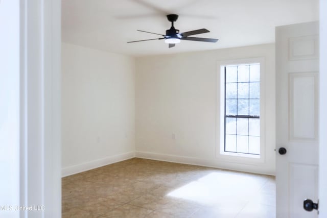 tiled empty room with ceiling fan