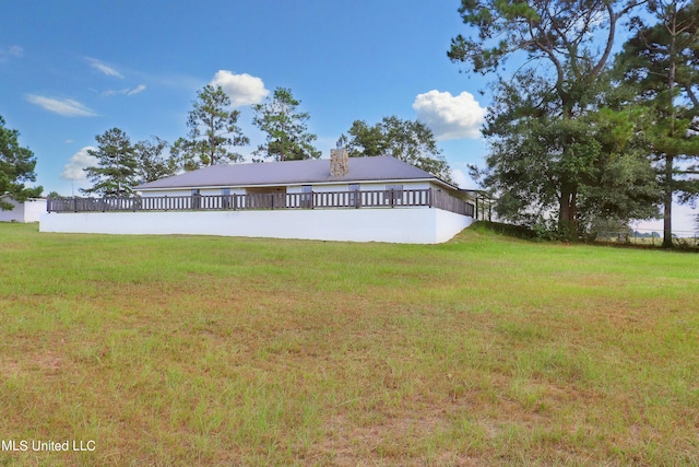 rear view of property with a yard