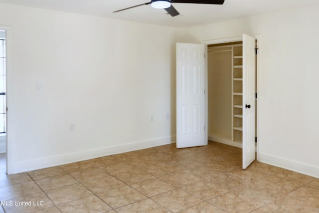 tiled empty room with ceiling fan