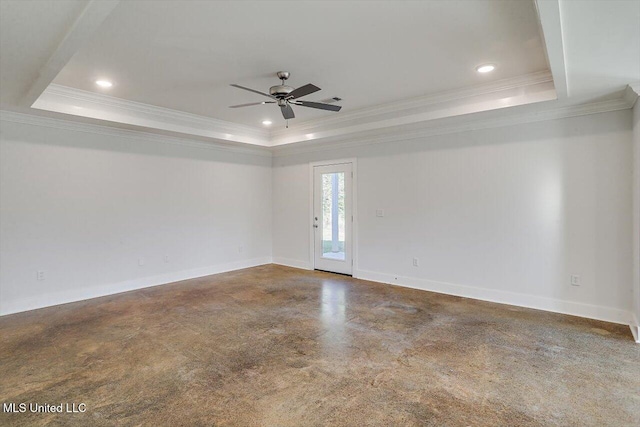 empty room featuring a tray ceiling, ceiling fan, and ornamental molding