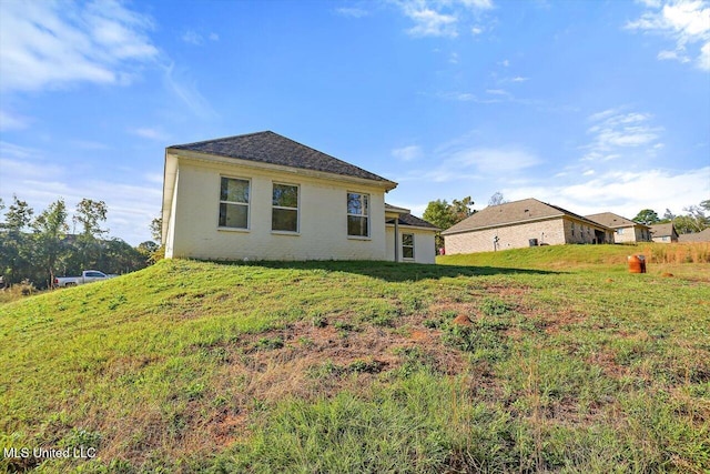 rear view of property with a yard