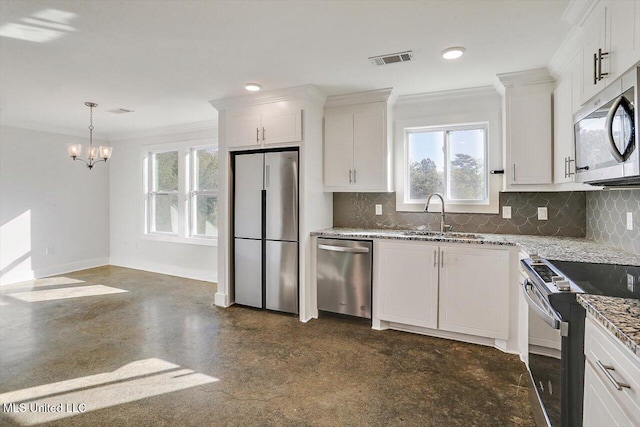 kitchen with appliances with stainless steel finishes, white cabinetry, plenty of natural light, and sink