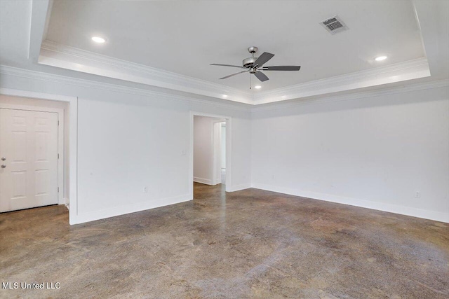 spare room with a tray ceiling, ceiling fan, and ornamental molding