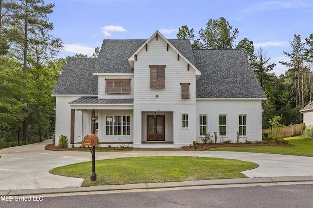 104 Westlake Cir W, Madison, MS 39110 - modern farmhouse style home featuring a standing seam roof, a shingled roof, board and batten siding, and curved driveway