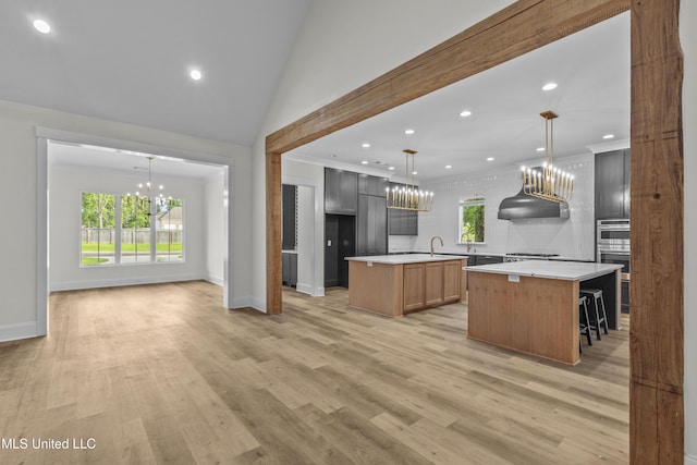 104 Westlake Cir W, Madison, MS 39110 - kitchen with a chandelier, a center island, light countertops, tasteful backsplash, and recessed lighting