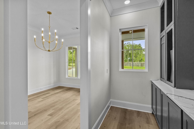 104 Westlake Cir W, Madison, MS 39110 - unfurnished dining area with light wood-type flooring, a chandelier, and crown molding