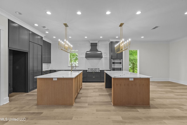 104 Westlake Cir W, Madison, MS 39110 - kitchen featuring a kitchen island with sink, a chandelier, healthy amount of natural light, crown molding, and custom exhaust hood