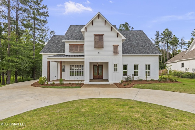 104 Westlake Cir W, Madison, MS 39110 - modern farmhouse featuring board and batten siding, a standing seam roof, a shingled roof, a front lawn, and covered porch