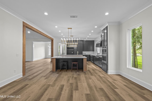 104 Westlake Cir W, Madison, MS 39110 - kitchen with light countertops, recessed lighting, ornamental molding, an island with sink, and a breakfast bar area