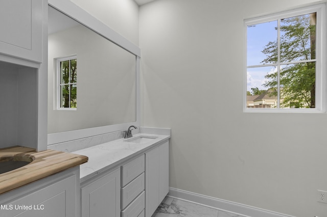 104 Westlake Cir W, Madison, MS 39110 - bathroom featuring healthy amount of natural light, marble finish flooring, and double vanity