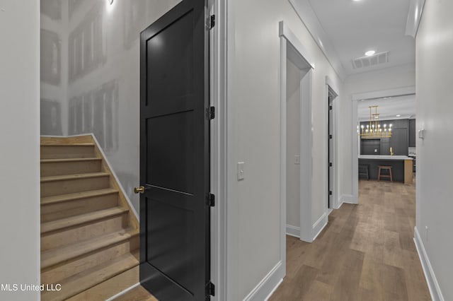 104 Westlake Cir W, Madison, MS 39110 - corridor with wood finished floors, stairs, a chandelier, recessed lighting, and crown molding