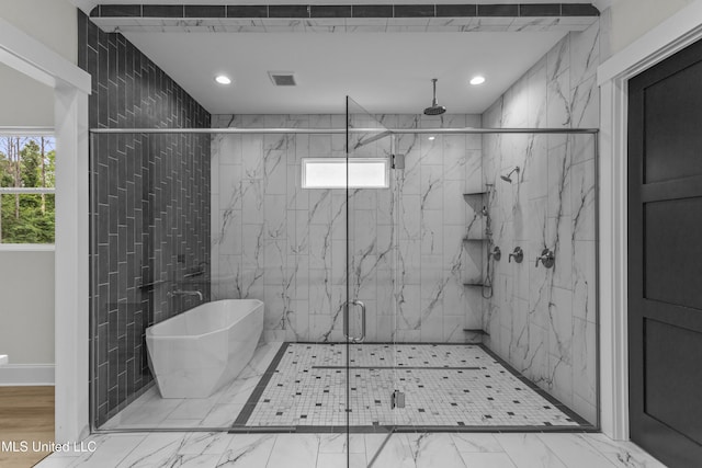 104 Westlake Cir W, Madison, MS 39110 - bathroom with a marble finish shower, healthy amount of natural light, a freestanding tub, marble look tiles, and recessed lighting