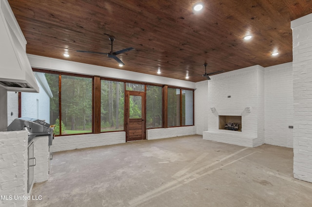 104 Westlake Cir W, Madison, MS 39110 - unfurnished living room featuring concrete flooring, a ceiling fan, wood ceiling, a fireplace, and brick wall