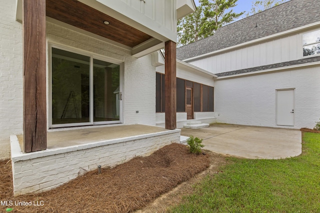 104 Westlake Cir W, Madison, MS 39110 - doorway to property with board and batten siding, brick siding, a patio, and a shingled roof