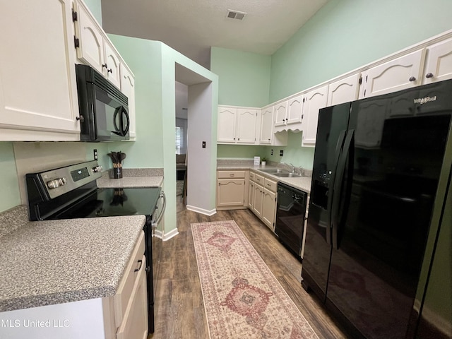 5306 Kristy Ln, Southaven, MS 38671 - kitchen with black appliances, dark wood-type flooring, white cabinetry, and light countertops