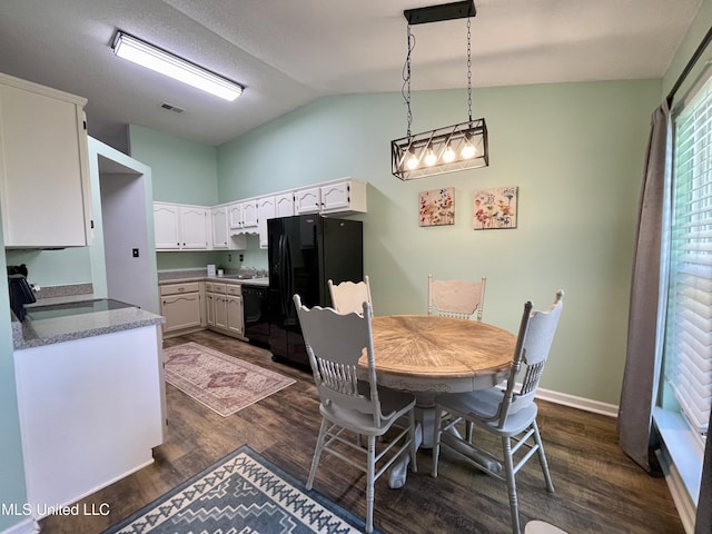 5306 Kristy Ln, Southaven, MS 38671 - dining room with dark wood-type flooring and vaulted ceiling