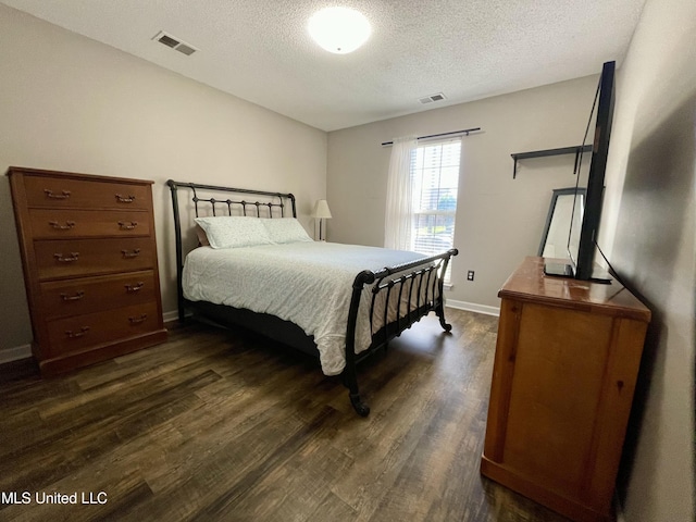 5306 Kristy Ln, Southaven, MS 38671 - bedroom featuring dark wood-style flooring and a textured ceiling