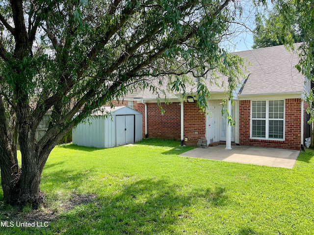 5306 Kristy Ln, Southaven, MS 38671 - view of green lawn featuring a patio and a storage unit