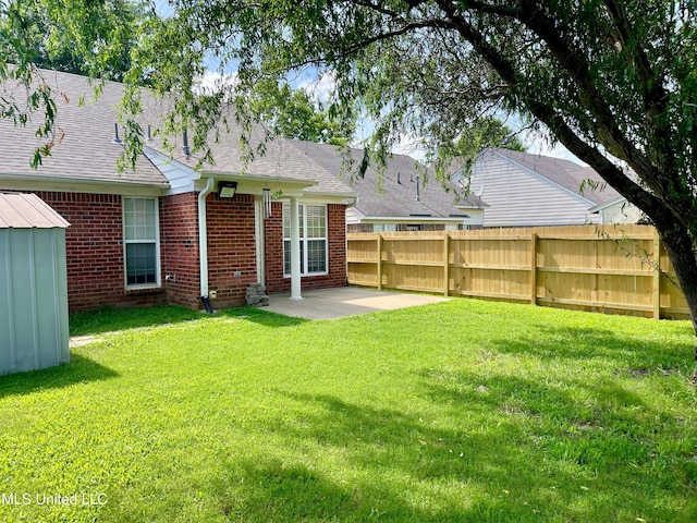 5306 Kristy Ln, Southaven, MS 38671 - back of property featuring a patio area, brick siding, roof with shingles, and a shed