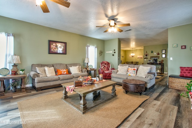 living room with hardwood / wood-style floors, ceiling fan, and a textured ceiling