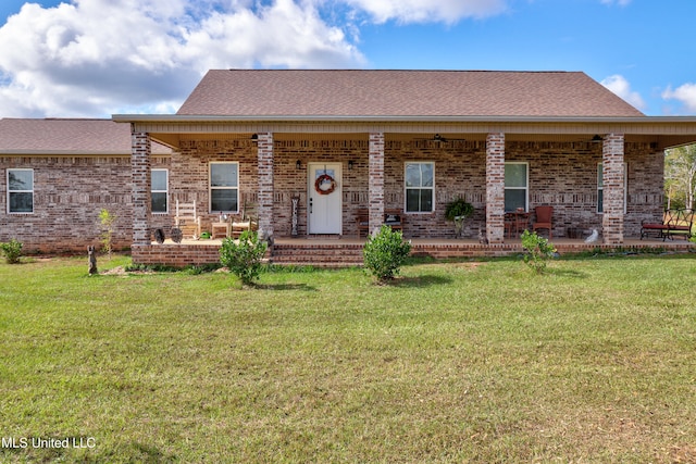 view of front of home with a porch and a front lawn