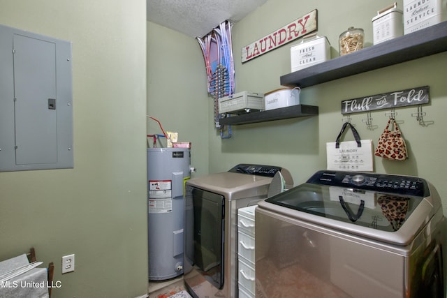 laundry room featuring washing machine and clothes dryer, water heater, a textured ceiling, and electric panel