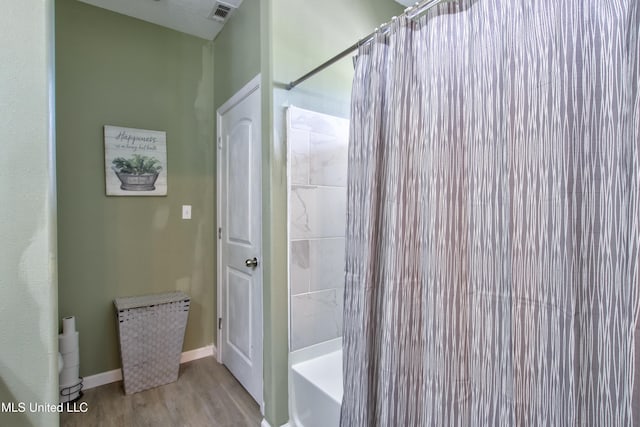 bathroom featuring hardwood / wood-style floors and shower / bath combo