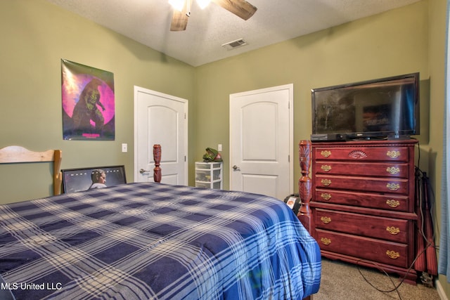 bedroom with ceiling fan, a textured ceiling, and carpet flooring