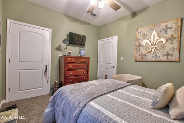 bedroom featuring a textured ceiling, ceiling fan, and carpet floors