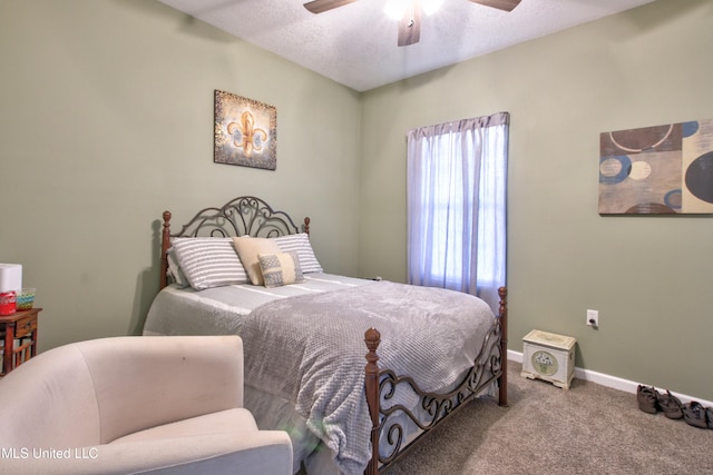 bedroom with a textured ceiling, carpet, and ceiling fan