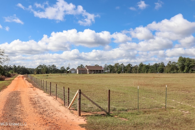 view of yard with a rural view