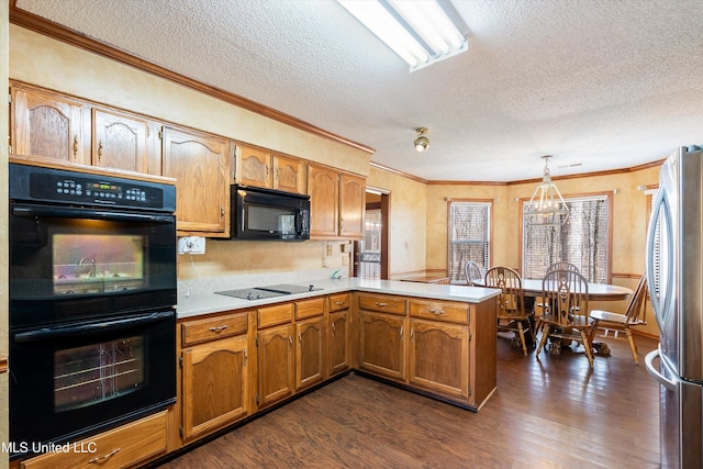 kitchen featuring black appliances, a peninsula, light countertops, and crown molding