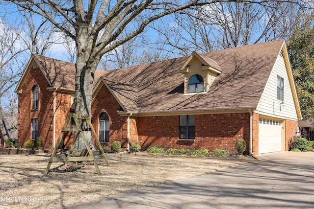 view of front facade with driveway, brick siding, an attached garage, and a shingled roof