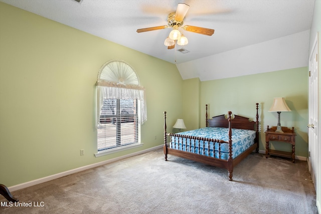 carpeted bedroom featuring a ceiling fan, visible vents, vaulted ceiling, and baseboards